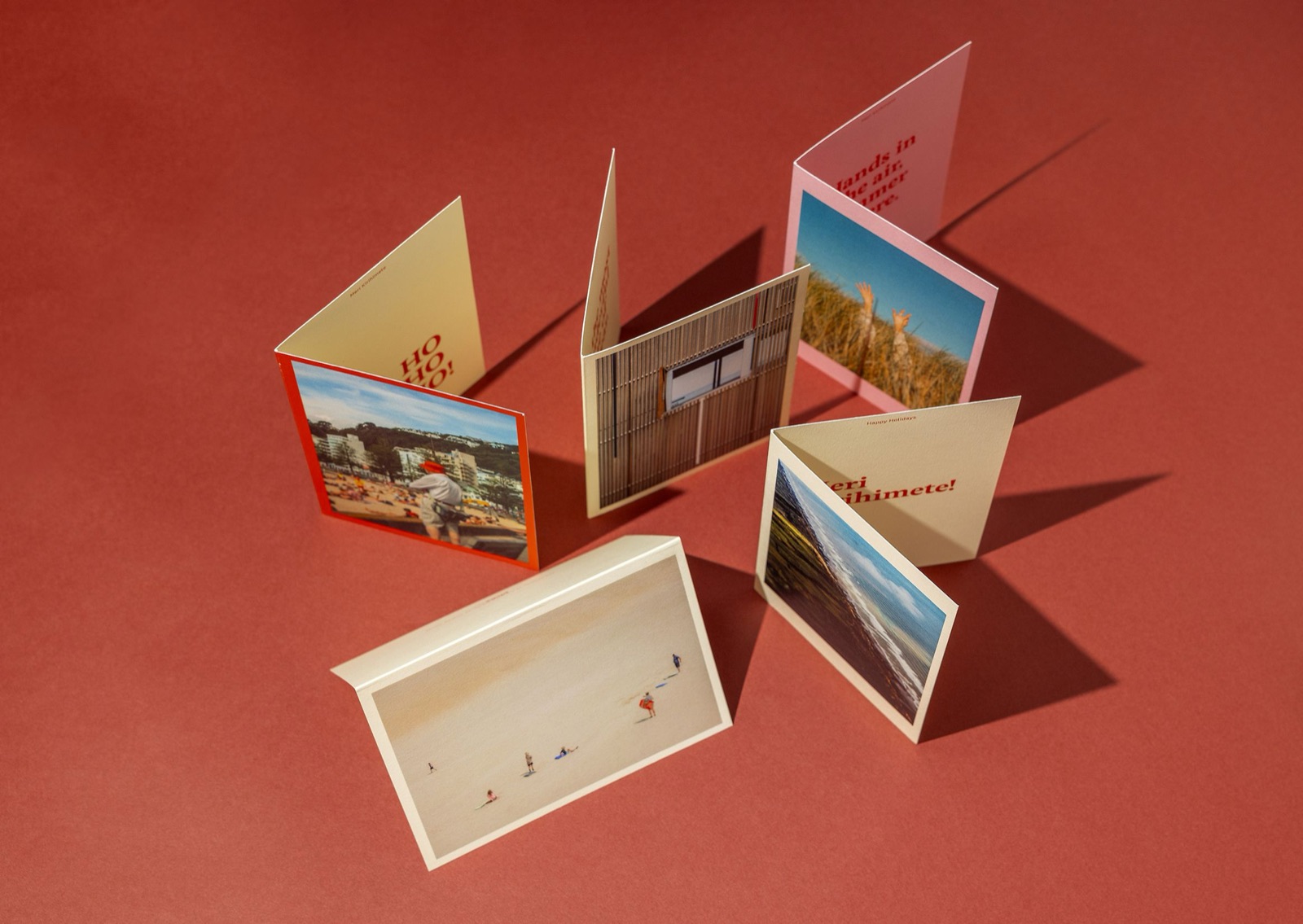 Five unfolded Picky Christmas cards standing upright, each featuring different Aotearoa photography and festive greetings