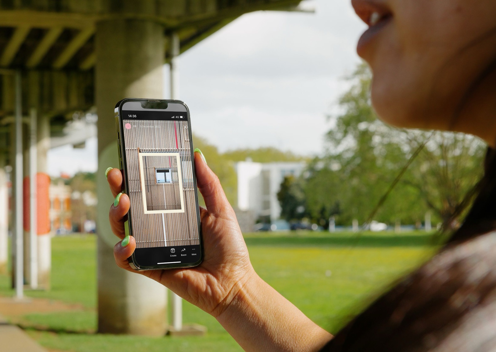 Woman using the Picky app on her phone to browse stock photography of a building