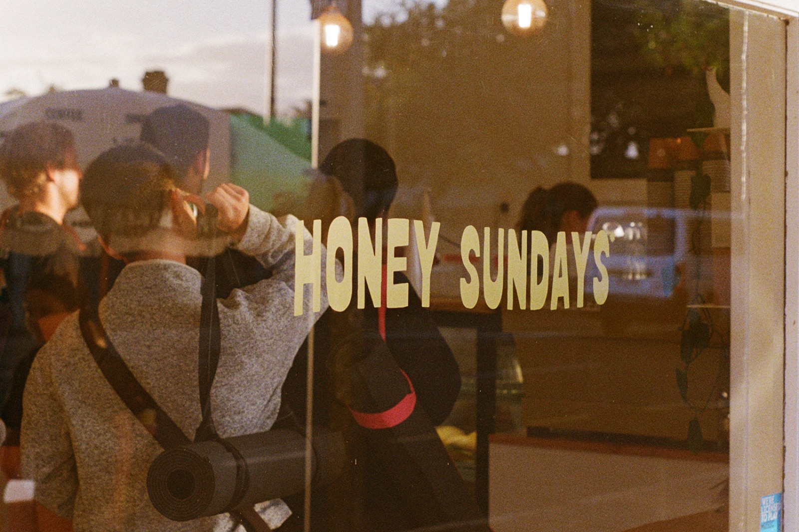 Stretchy group sitting outside Honey Sundays café after a session, with yoga mats and a small dog